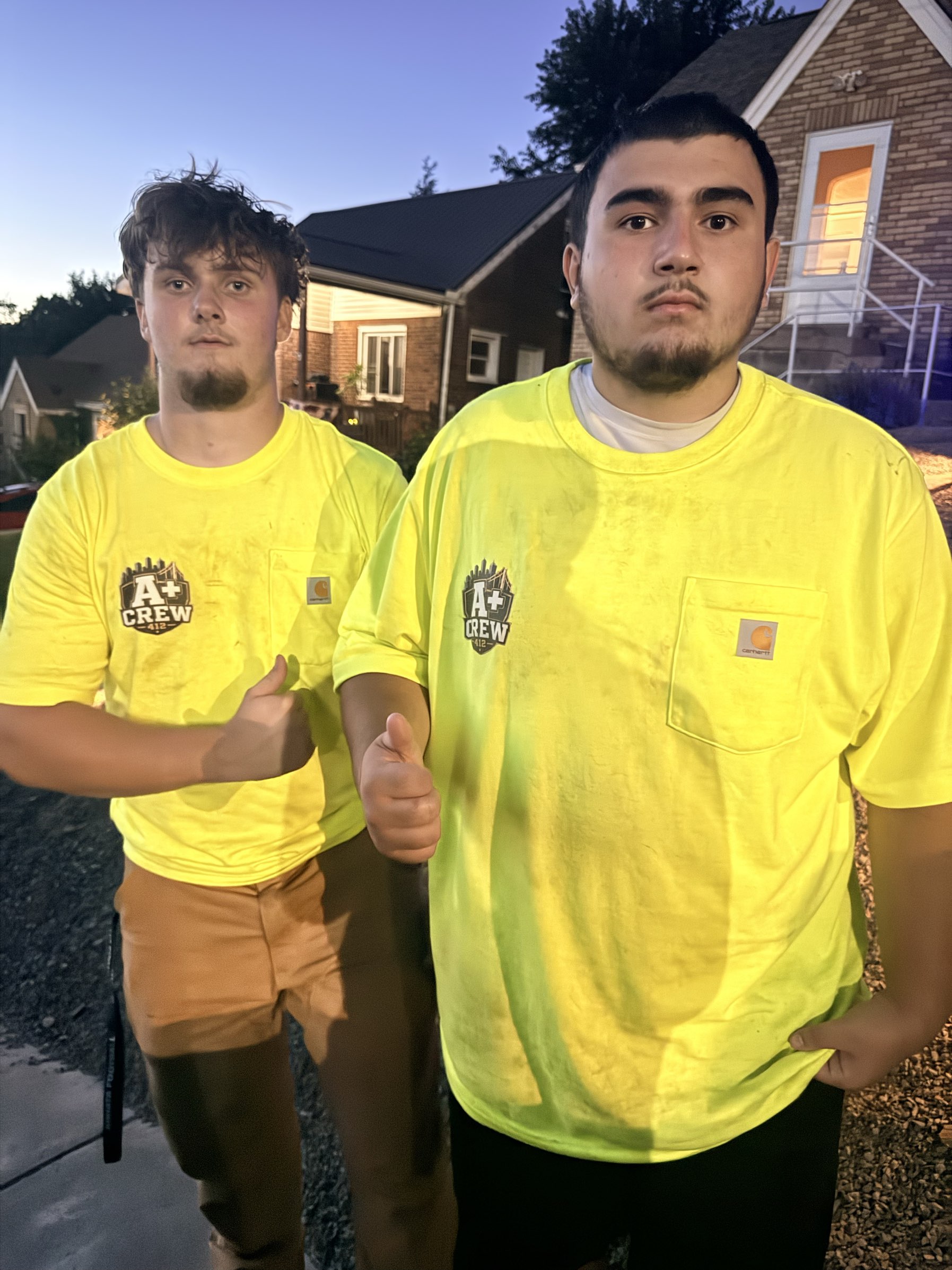 Two A+ Crew members in uniform after a job