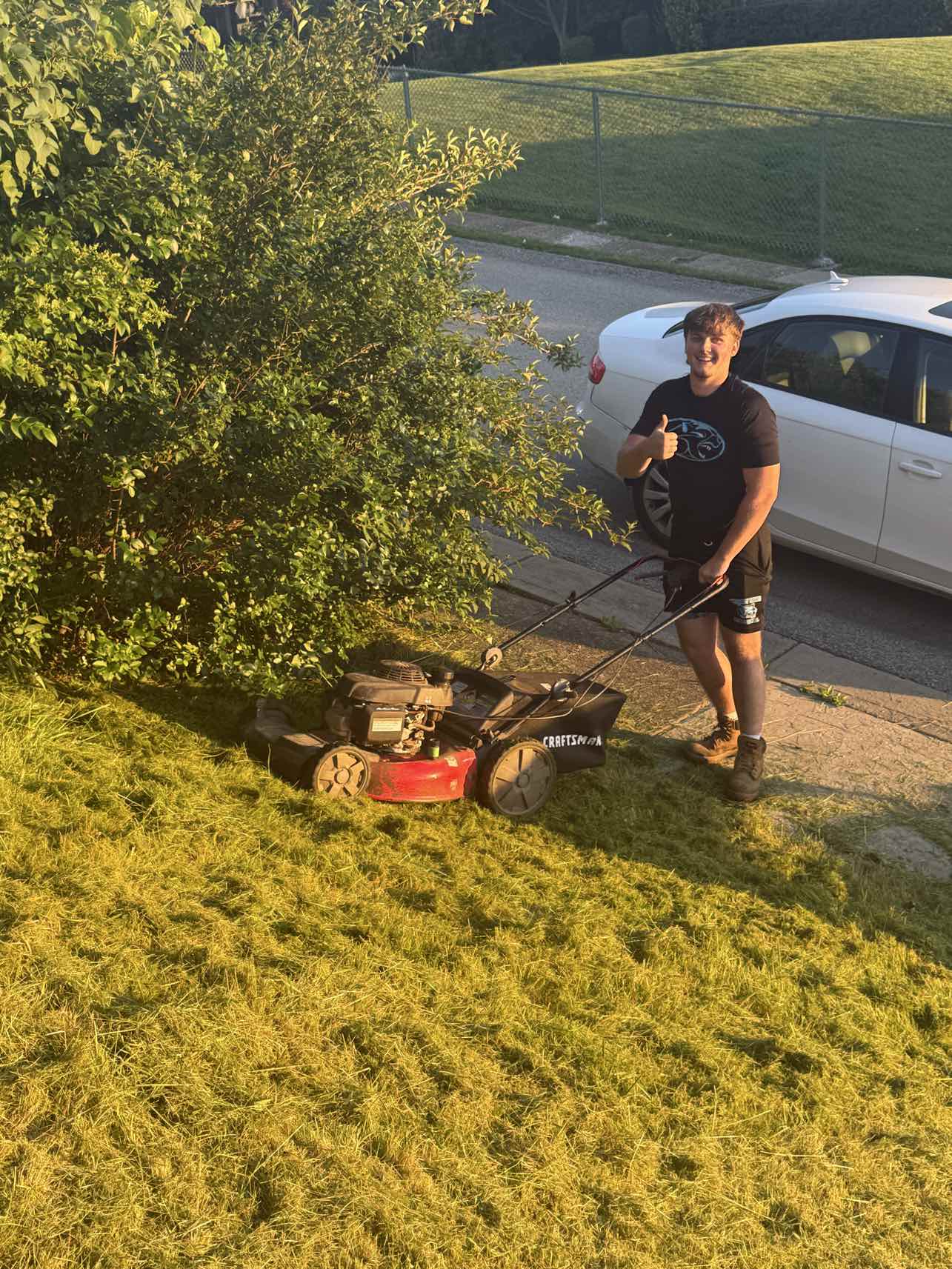 A+ Crew member with a mower on a freshly cut lawn