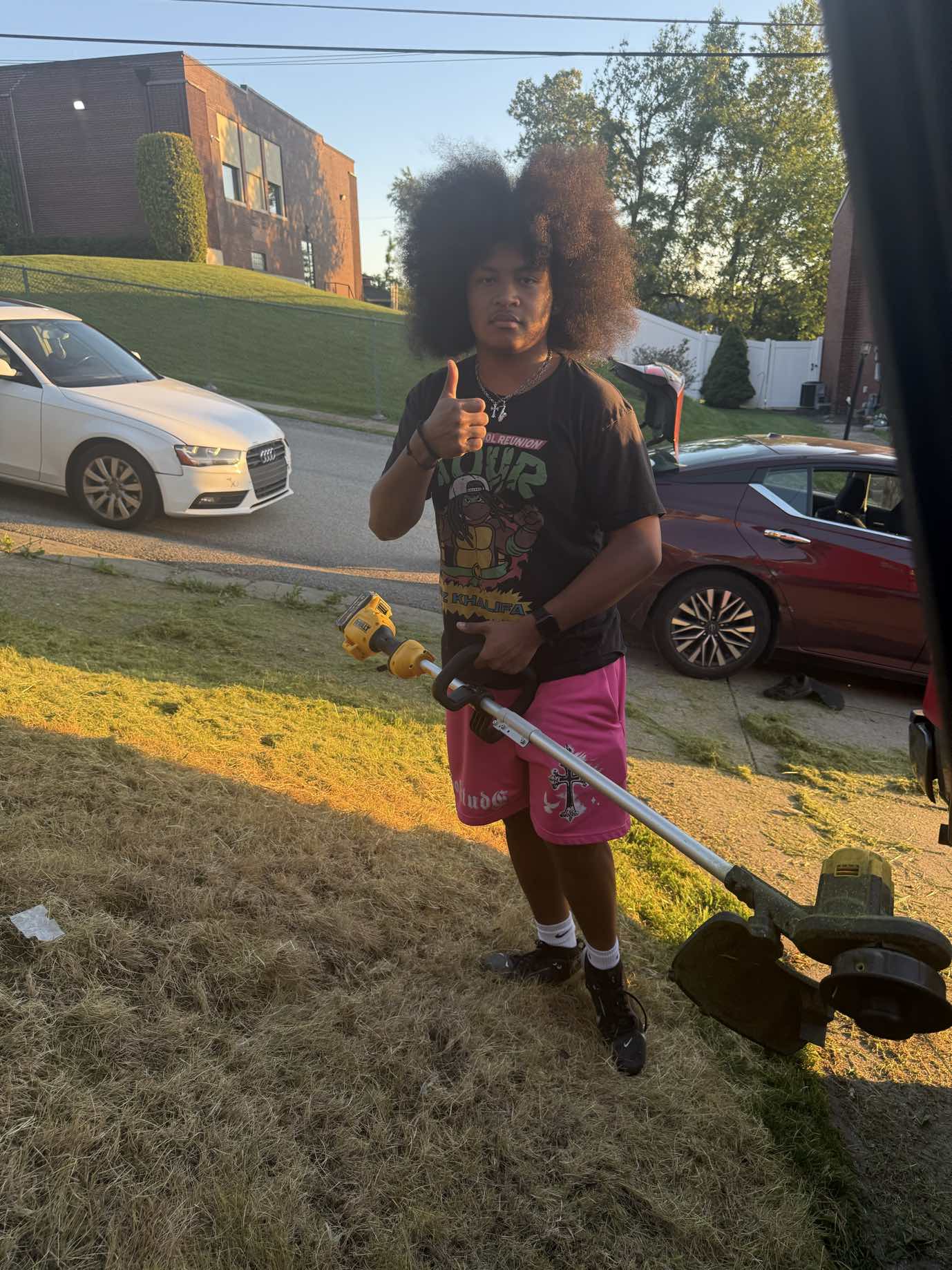 A+ Crew member edging with a string trimmer